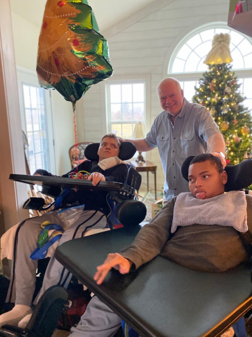 Alex, their dad, and Victor at home at Christmas